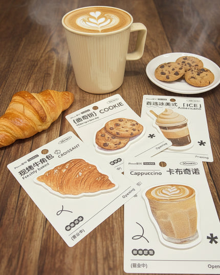 Three card-style illustrations of cookies, a croissant, and a cappuccino with a beige mug on a dark surface.