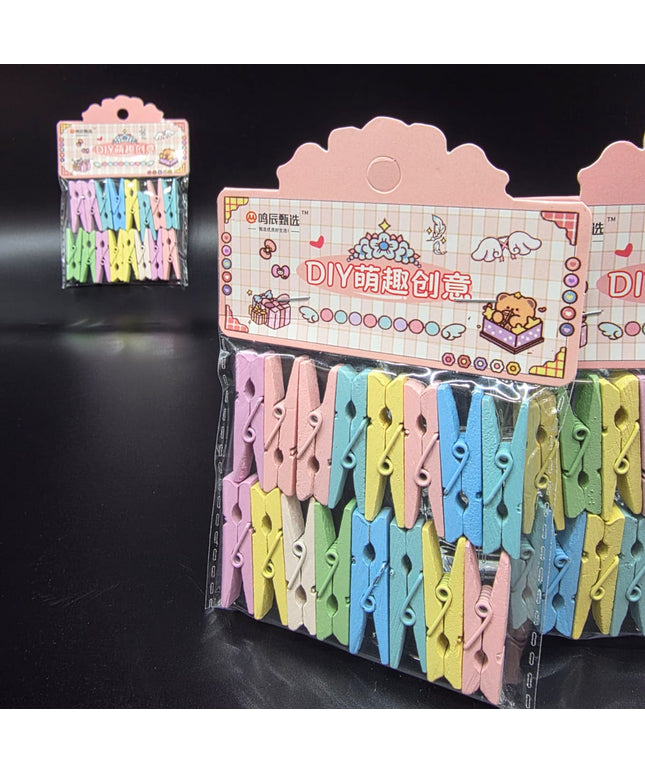 Colorful clothespins in a clear plastic package with a pink display stand on a black background.