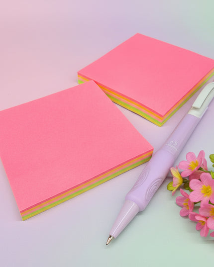 Two pink sticky notes with a purple pen on a black background