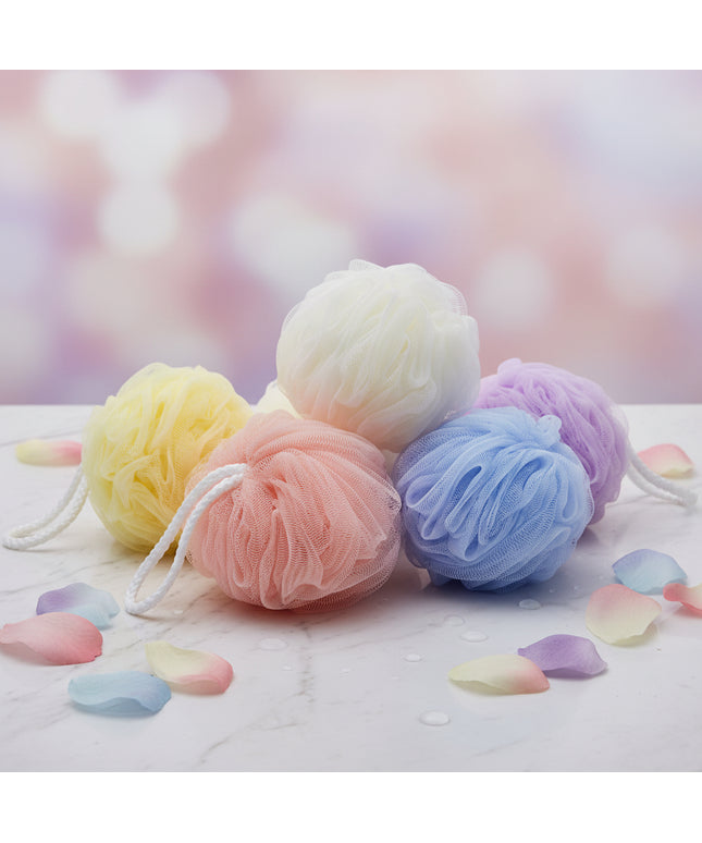 Four colorful bath pouf sponges on a white background