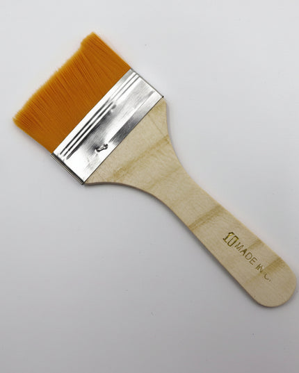 Paint brush with wooden handle and brown bristles on a white background