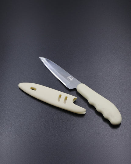 Paring knife with a beige handle on a dark gray background