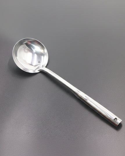Silver ladle on a gray background