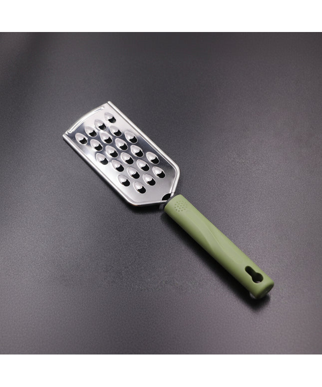 Metal grater with a green handle on a gray background