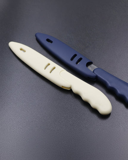 Two plastic knives with blue and beige handles on a dark gray background