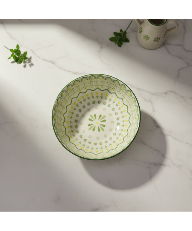 Decorative ceramic plate with green floral pattern on a white background