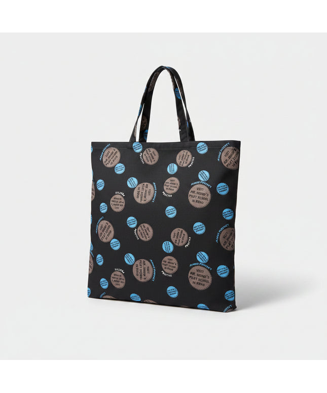 Black tote bag with blue and brown circular patterns on a white surface