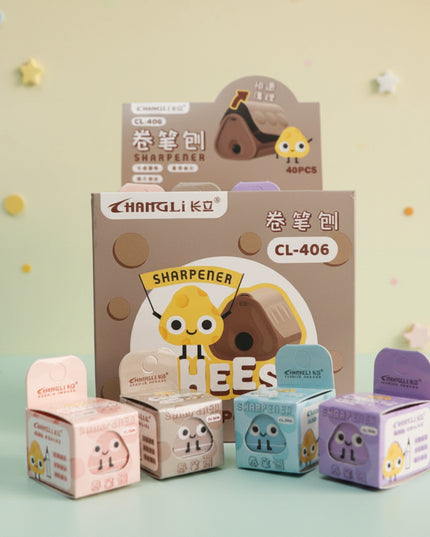 Set of cartoon-themed stationery items including a sharpener and small boxes on a gray background