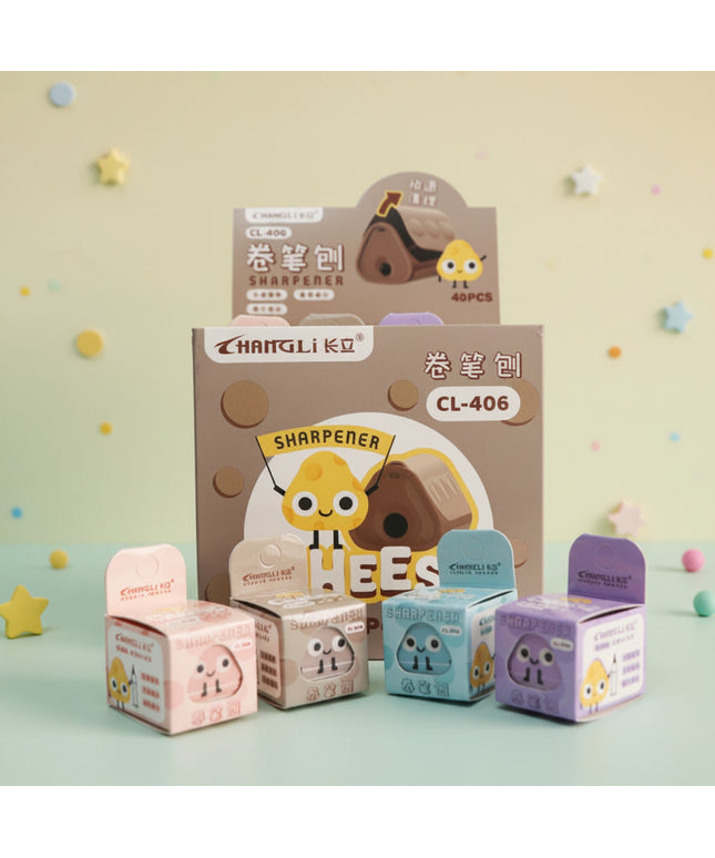 Set of cartoon-themed stationery items including a sharpener and small boxes on a gray background