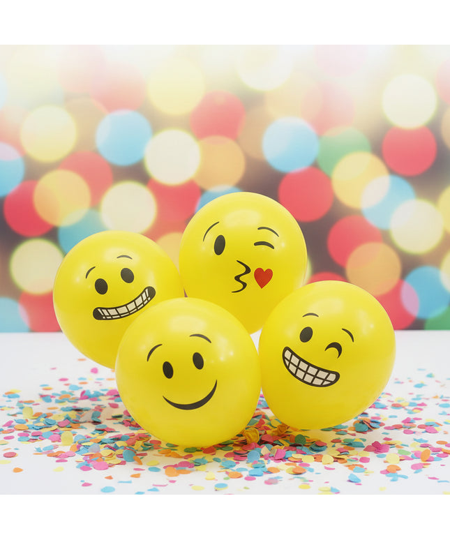 Yellow balloons with various emoji faces on a white background