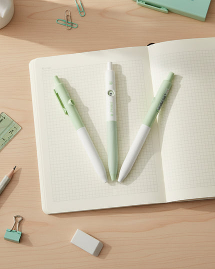 Two green and white pens on a light gray background