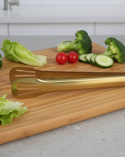 Three gold-colored spatulas with yellow handles on a white background