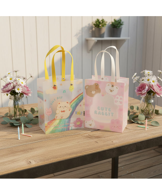 Two small gift bags with colorful designs featuring cartoon bears on a gray background.