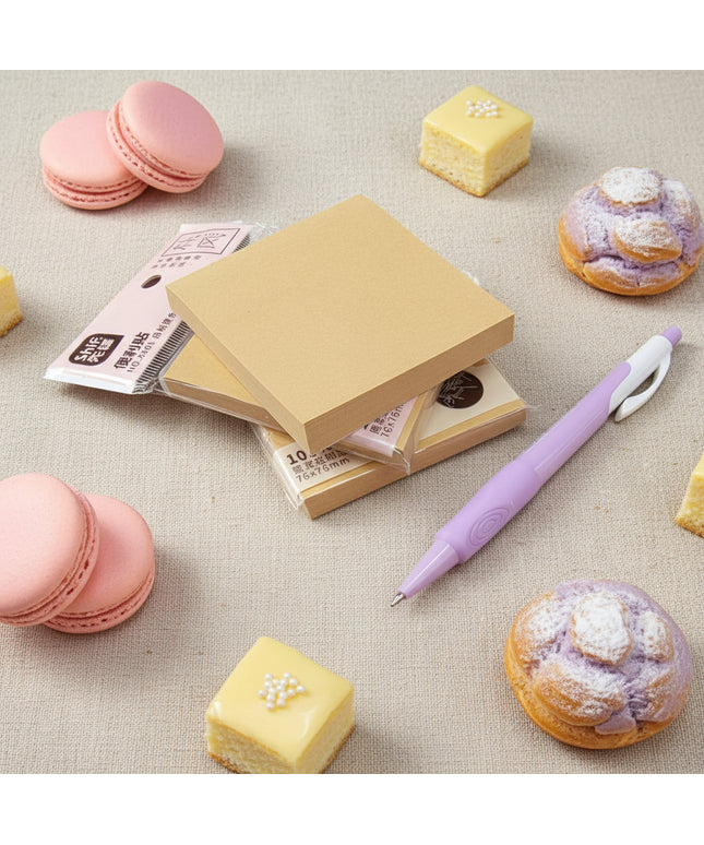 Stack of yellow sticky notes with a purple pen on a dark surface