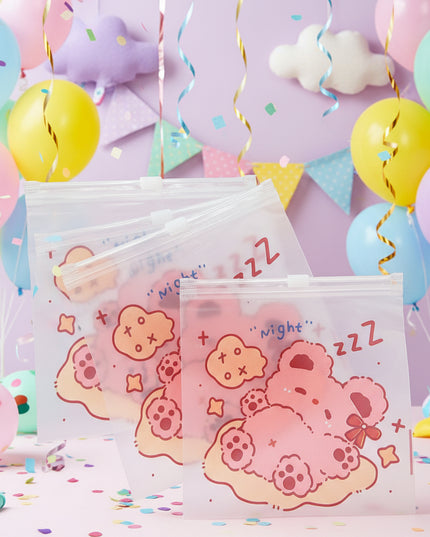 Set of three clear plastic bags with cartoon designs and text on a dark background