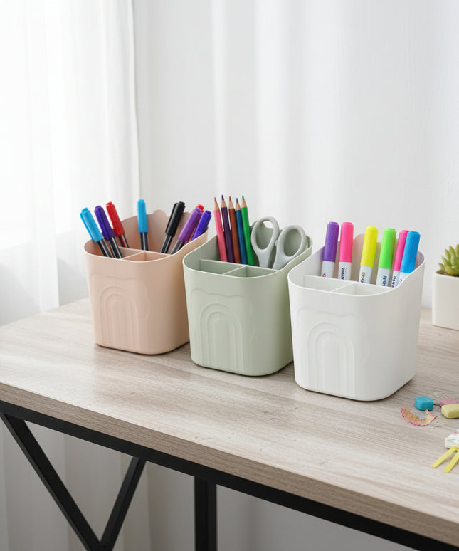 Three small storage bins in beige, green, and white on a cardboard surface.