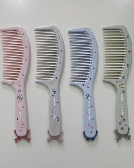 Four combs with decorative handles on a white background