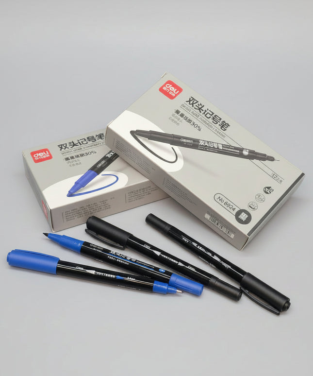 Two blue markers and two black markers with their packaging on a dark surface