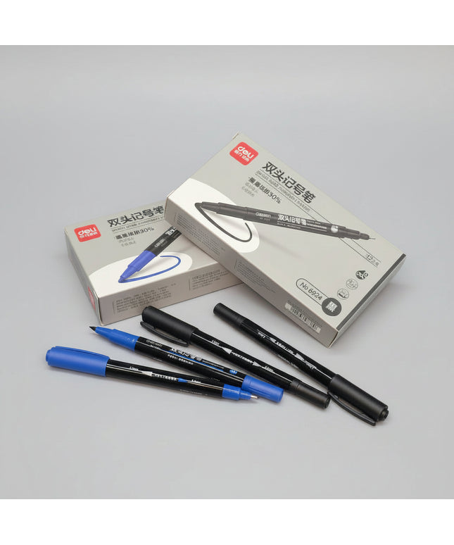 Two blue markers and two black markers with their packaging on a dark surface