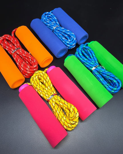 Set of colorful jump ropes on a dark background