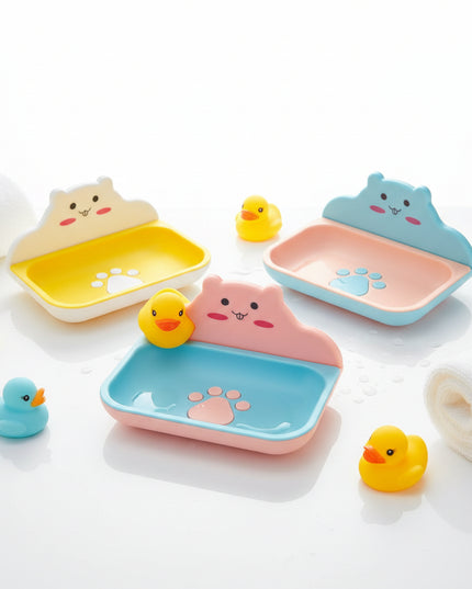 Three colorful pet bowls with cartoon faces on a black background