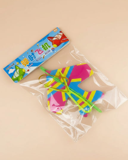 Colorful toy aircraft in clear packaging on a dark background