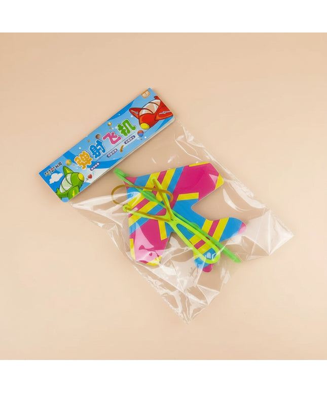 Colorful toy aircraft in clear packaging on a dark background