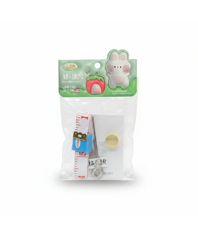 Packaged sewing kit with needle, thread, and measuring tape on a black background
