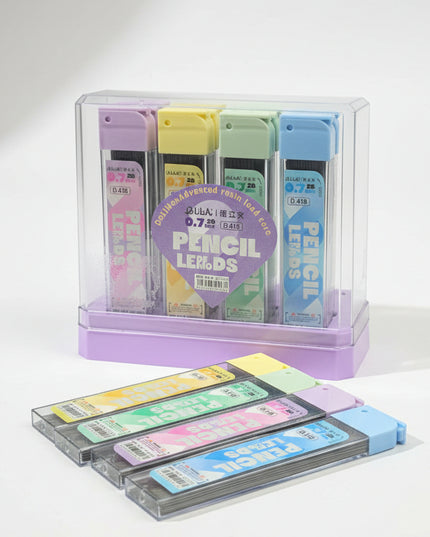Set of colorful pencil leads in a clear holder on a black background