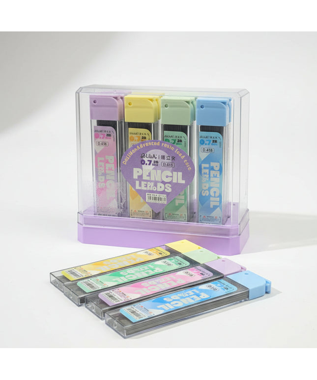 Set of colorful pencil leads in a clear holder on a black background