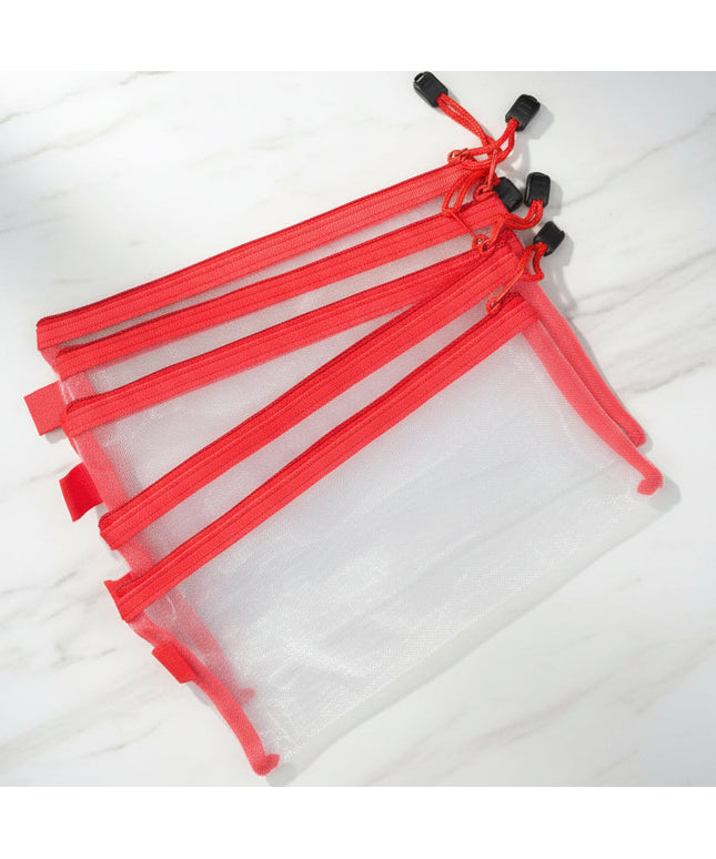Set of clear plastic bags with red zippers on a dark background