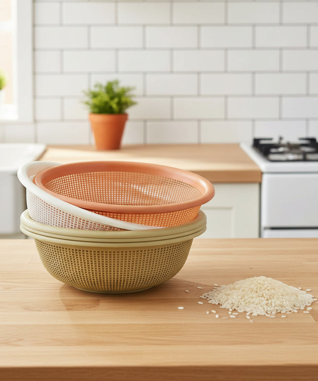 Two strainers stacked on a cardboard box with a white wall in the background.