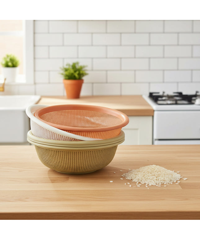Two strainers stacked on a cardboard box with a white wall in the background.