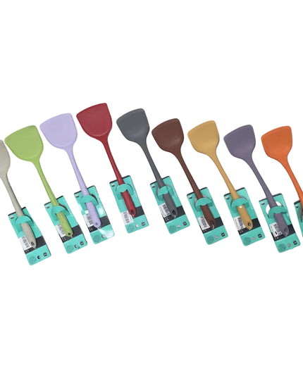 A set of ten silicone kitchen spatulas in various colors, each still in its original teal packaging, arranged in a row on a gray tiled floor.