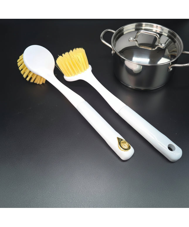 Two white cleaning brushes with yellow bristles on a black background